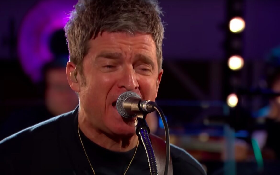 watch-noel-gallagher-cover-joy-division’s-“love-will-tear-us-apart”-with-the-bbc-concert-orchestra