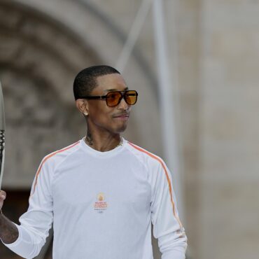 pharrell-williams-carries-torch-at-paris-2024-olympics